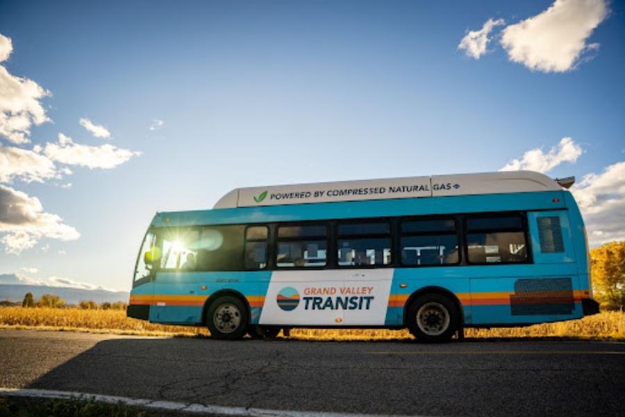 Large blue bus with Grand Valley Transit logo. 