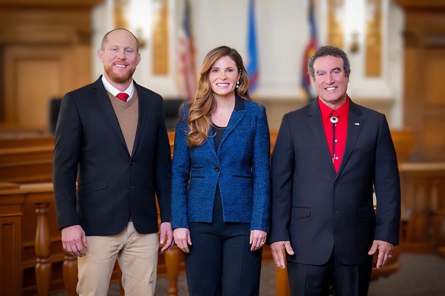 Three individuals (2025 Board of Mesa County Commissioners, Cody Davis, Bobbie Daniel, JJ Fletcher from left to right) next to each other smiling for headshots.