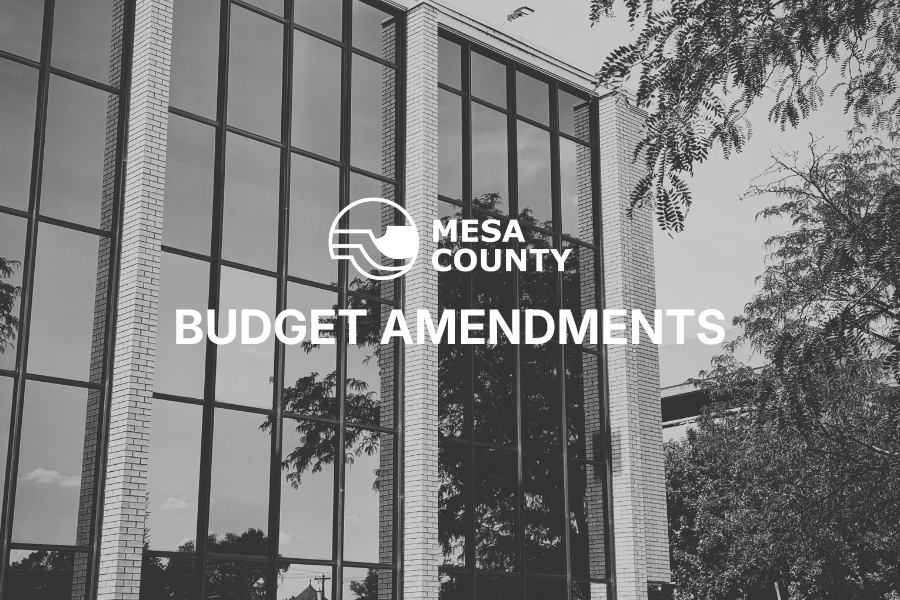 Black and white photo of the Old Mesa County Courthouse annex building with the county logo and the words “budget amendments.”